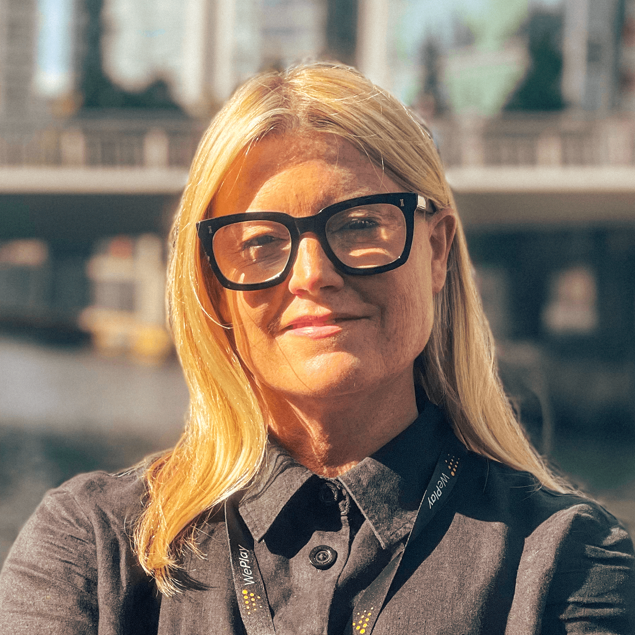 Woman with blonde hair and glasses